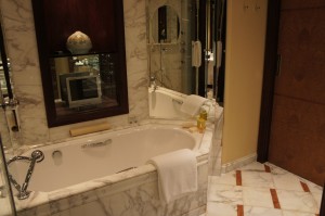 a bathroom with a bathtub and a mirror
