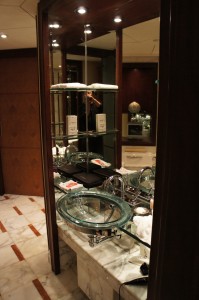a bathroom with a glass shelf