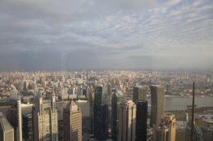 a cityscape with a river and clouds