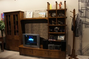 a room with a tv and shelves