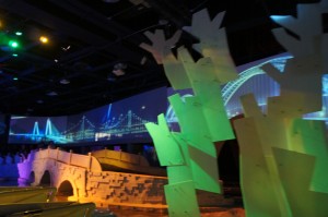 a stage with a bridge and trees