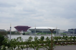 a large white building next to a body of water