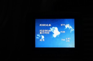The image shows a screen displaying flight information in Chinese. The background is a blue sky with white clouds. The text includes various pieces of information such as the destination, flight time, and other relevant details. The numbers "8711" and "744" are visible, along with the time "11:09".