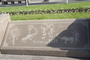 a stone wall with drawings on it