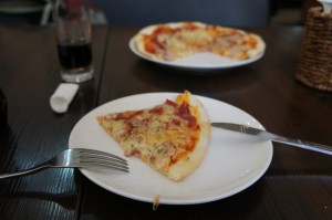 a plate of pizza with a fork and knife