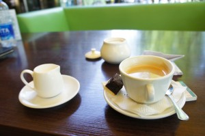 a cup of coffee and saucer on a table