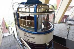 a cable car with a blue and white cab