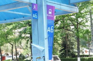 a blue awning with white and purple signs
