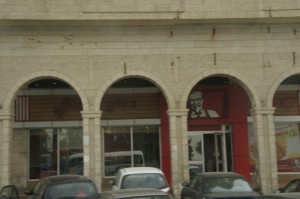 a building with many cars parked in front of it