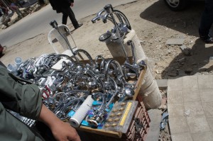 a man standing next to a table full of faucets