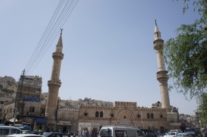 a building with towers and cars