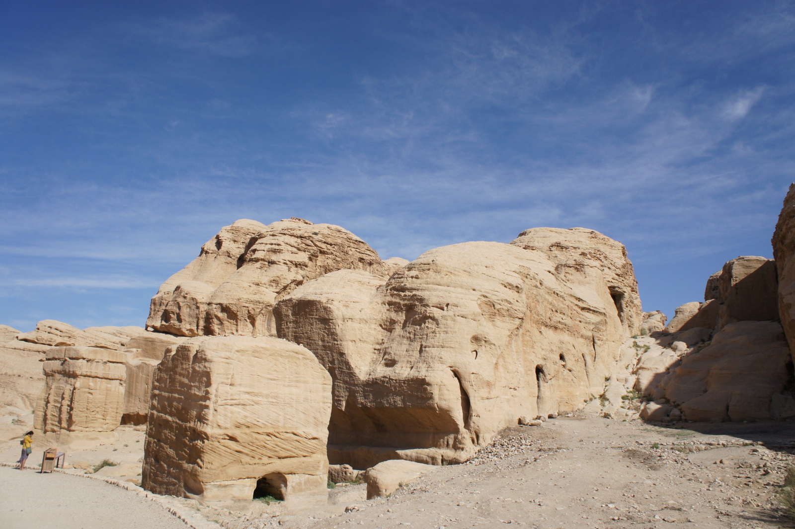 a large rock formation with a blue sky