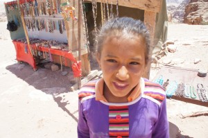 a young girl smiling at the camera