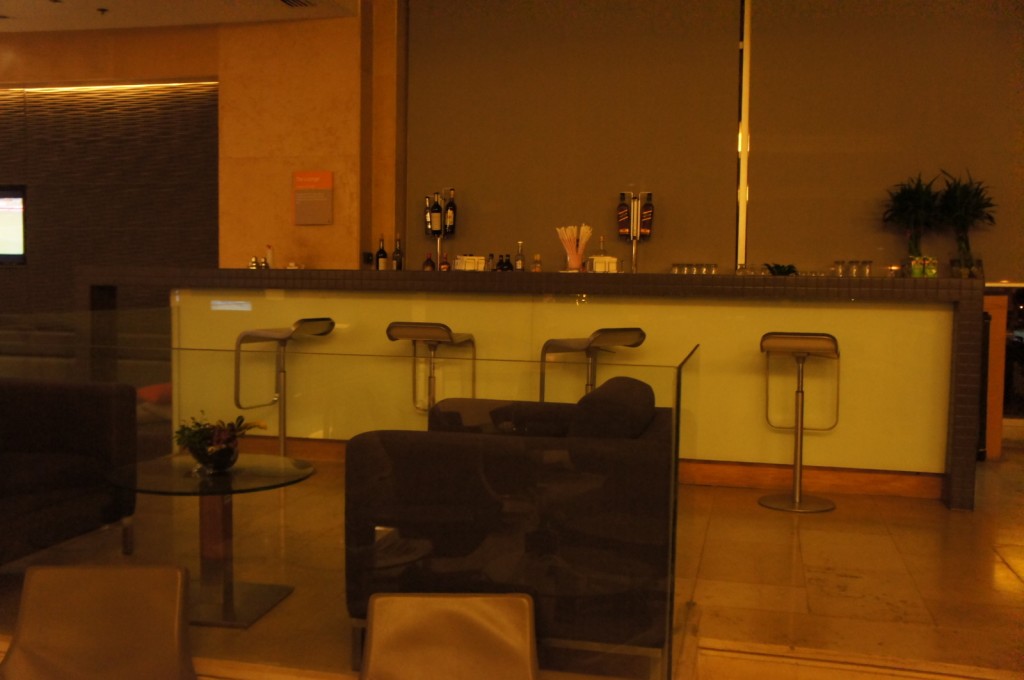 a bar with chairs and a glass table