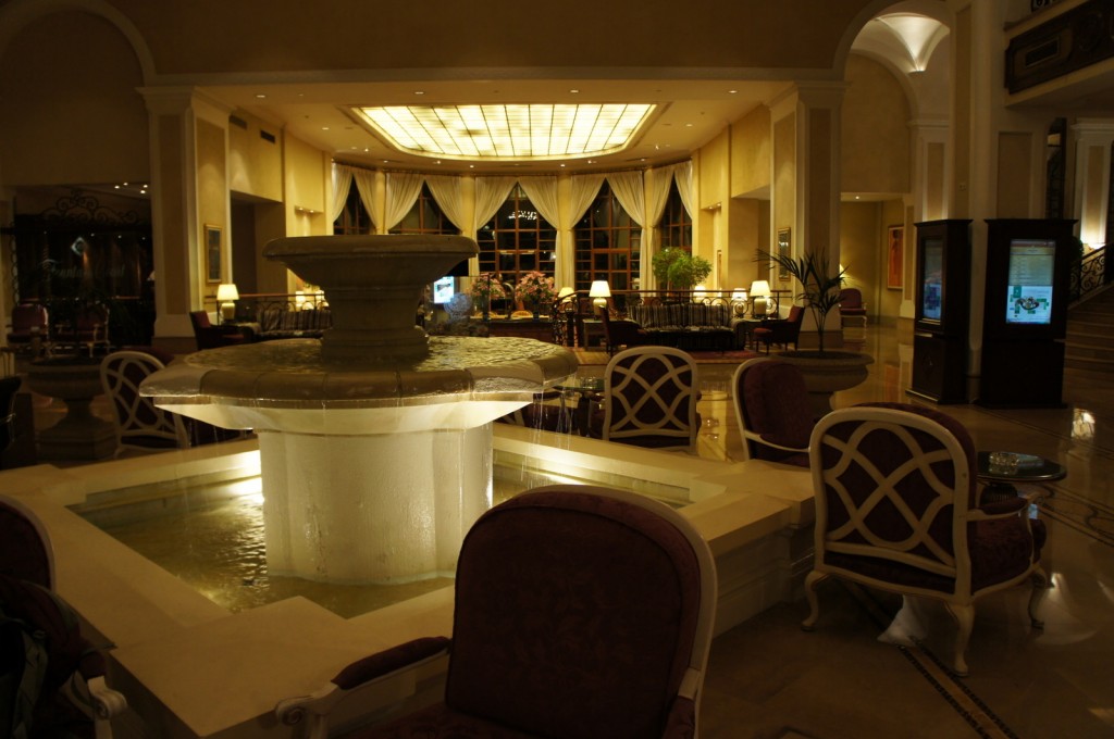 a room with a fountain and chairs