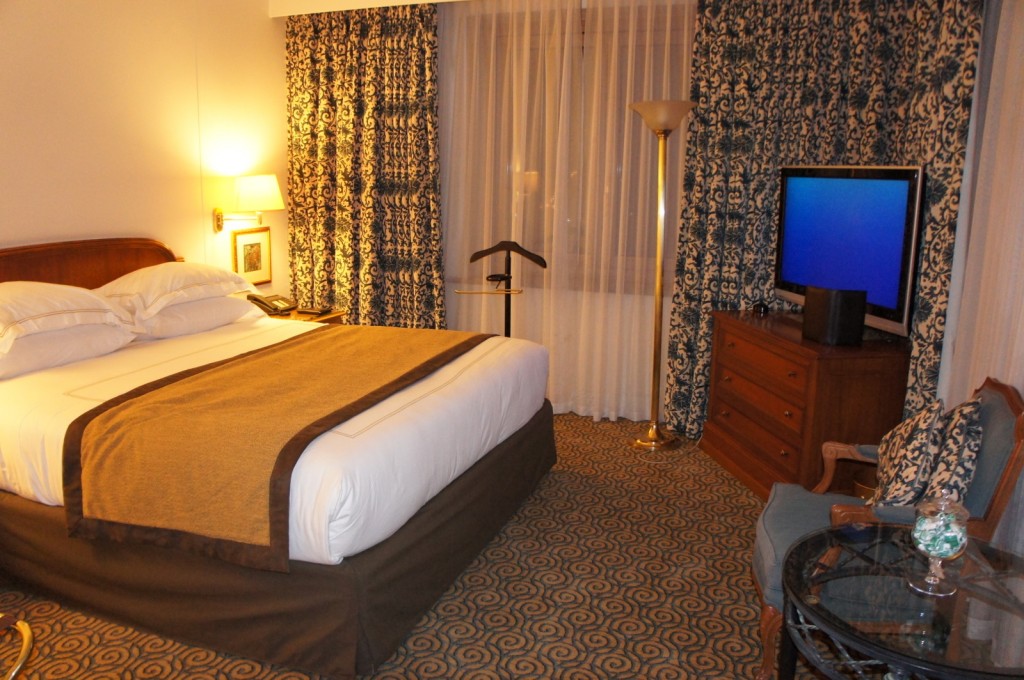 a hotel room with a bed and a television