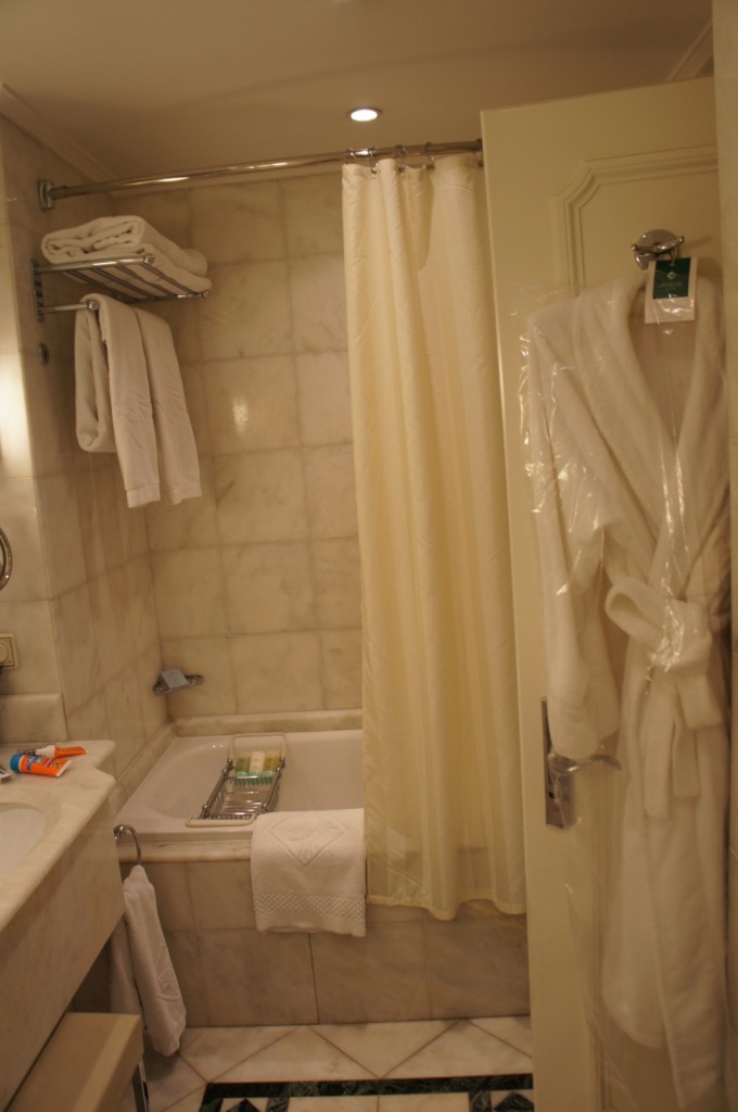 a bathroom with a bathtub and bathrobe