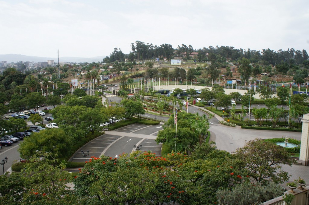 a parking lot with trees and a road