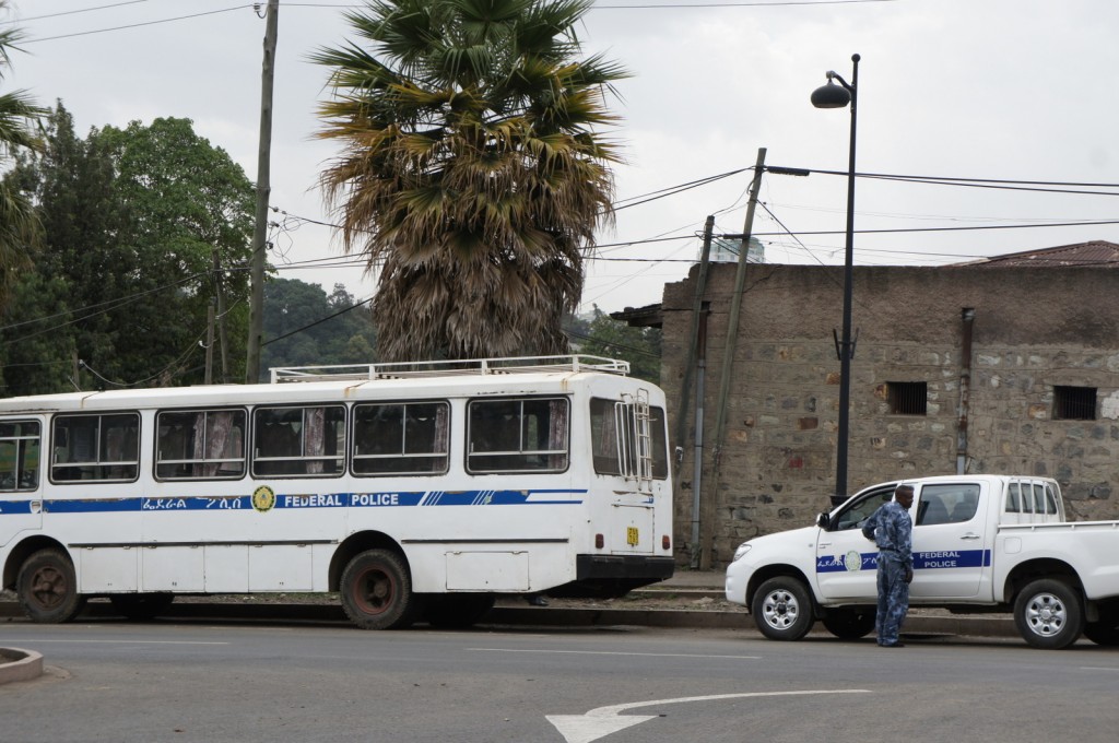 a police officer standing next to a bus