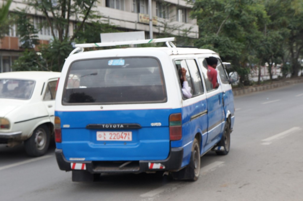 a blue and white van on a street
