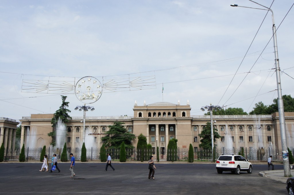 a large building with a fountain in the background