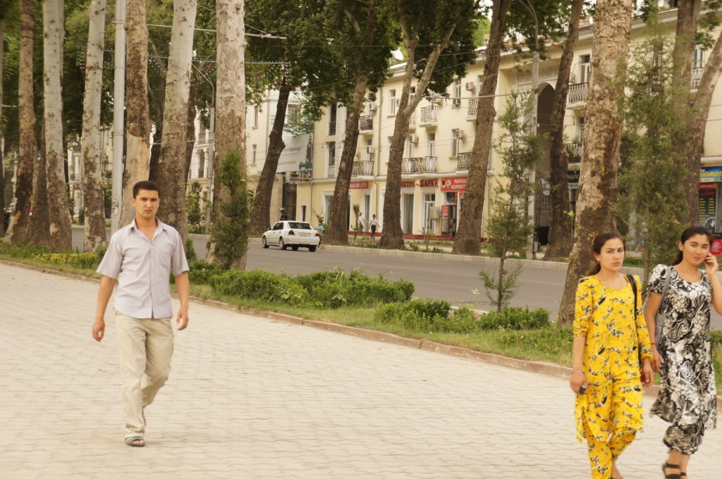 a man and woman walking on a sidewalk