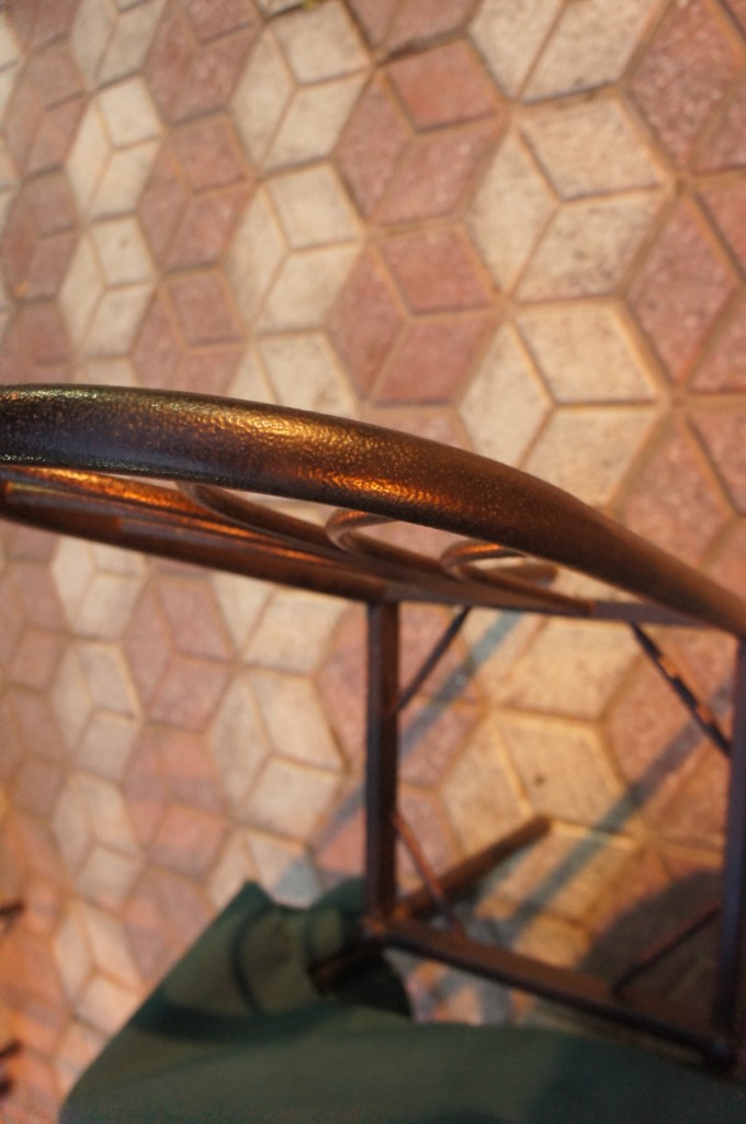 a metal chair with a metal arm rest