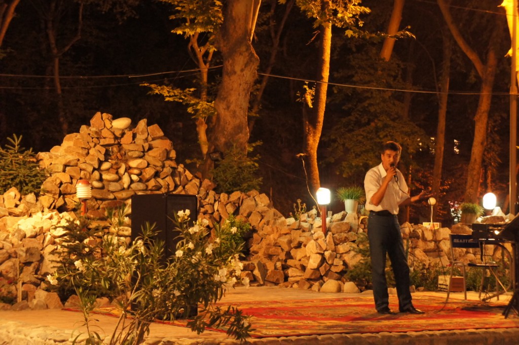 a man standing on a rug with a microphone
