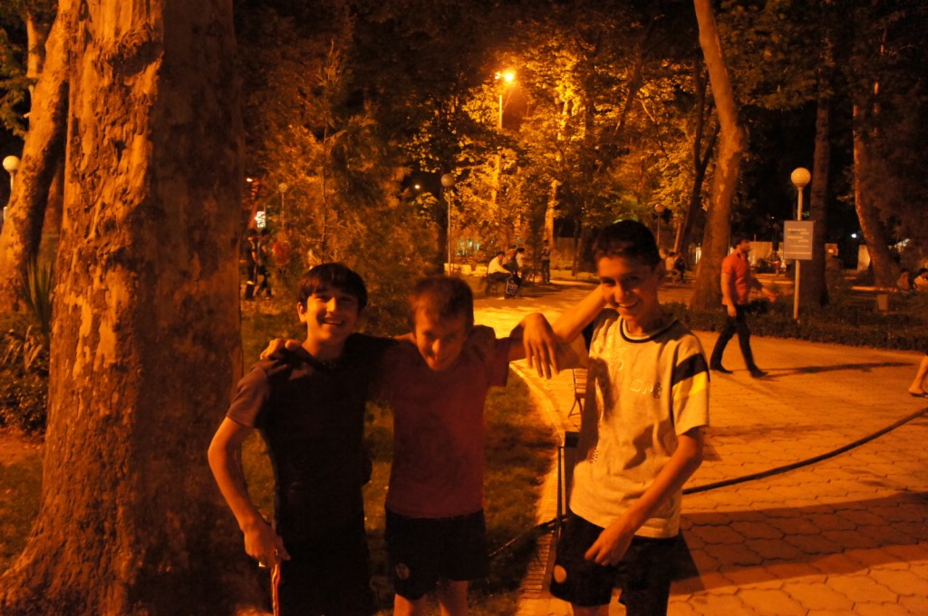 a group of boys standing together outside at night