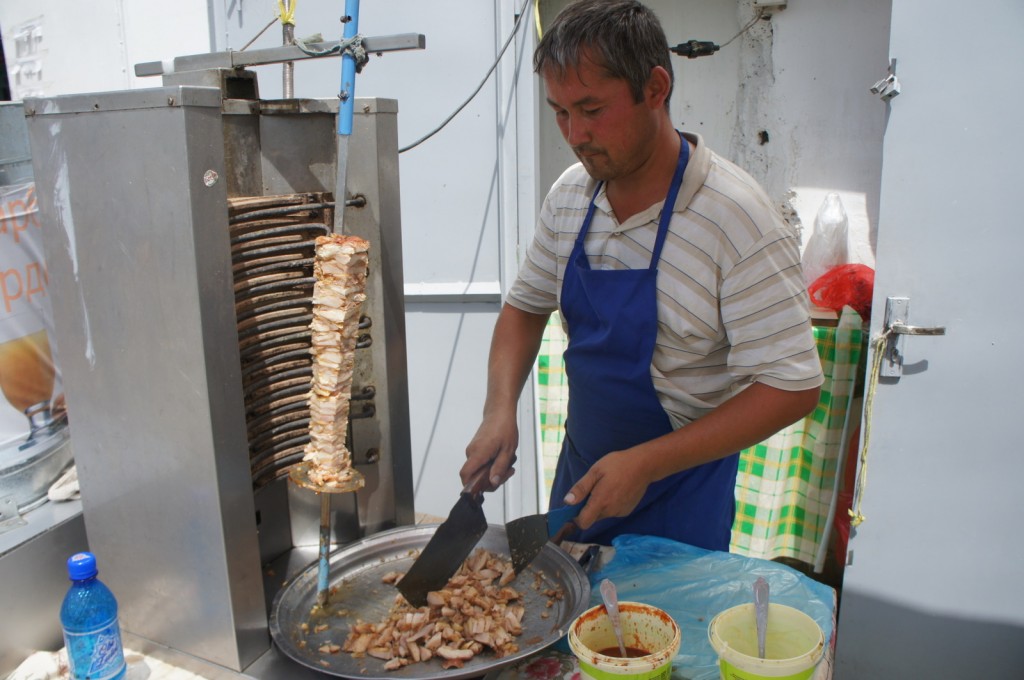 a man cooking meat on a spit