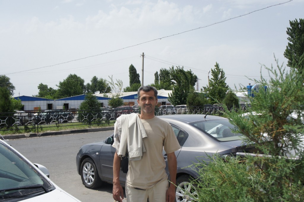 a man standing in front of a car