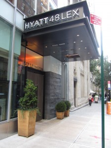 a hotel entrance with a sign