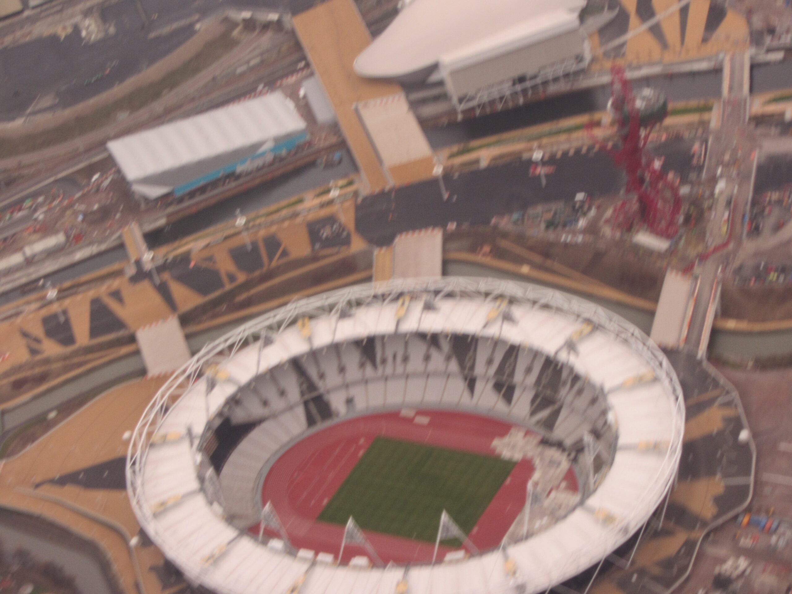 a stadium with a red field and a white stadium