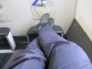 a person's legs and feet in a chair