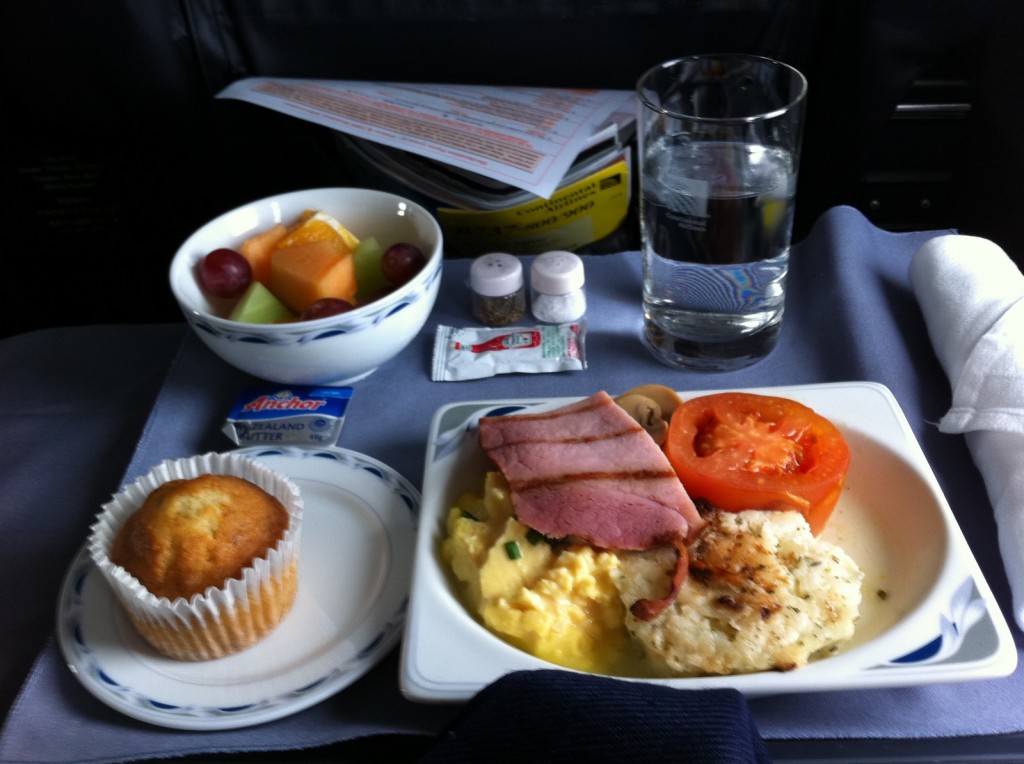 a plate of food and a muffin on a tray