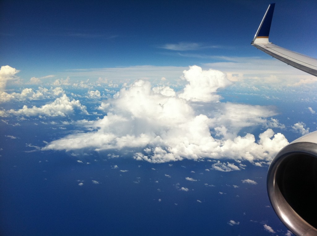 an airplane wing and clouds