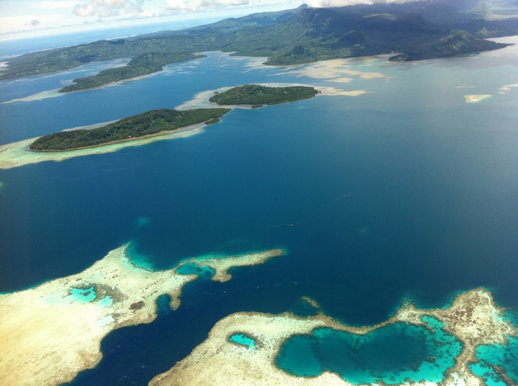 an aerial view of a body of water with islands and mountains