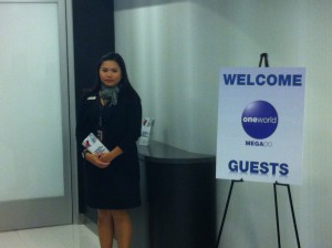 a woman standing next to a sign