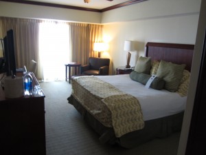 a hotel room with a bed and a desk