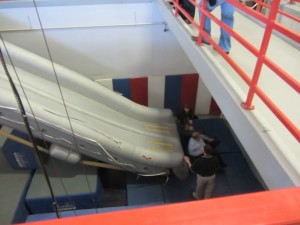 a group of people standing around a slide