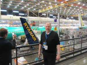 a man taking a picture of a man in a hangar