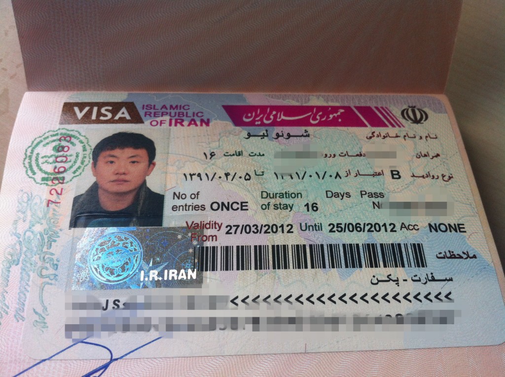The image shows an Iranian visa inside a passport. The visa includes a photograph of the visa holder, personal details, visa type, number of entries allowed, duration of stay, validity dates, and other relevant information. Some of the text is in Persian, and there are official stamps and a holographic security feature on the visa. The personal details and some other information have been blurred for privacy.
