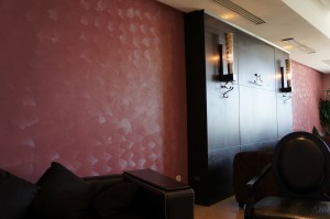 a room with a pink wall and a couch