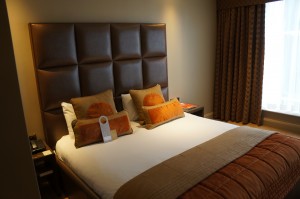a bed with brown pillows
