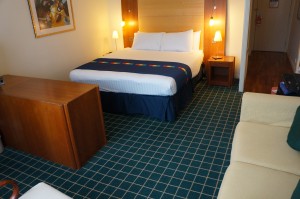 a hotel room with a bed and a couch