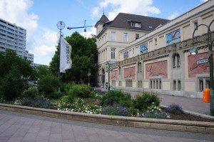 a building with a garden and a flag