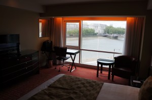 a room with a bed and a table and chairs