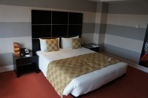 a bed with pillows and a table
