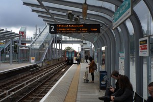 people sitting on a platform at a train station
