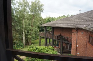 a house with a balcony and trees